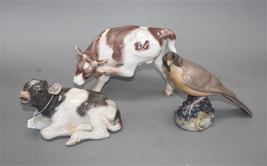 Two Royal Copenhagen figures of a bird, model 1235 and a calf, model 1072 and a Bing & Grondahl calf, no. 1826, 16 - 18.5cm
